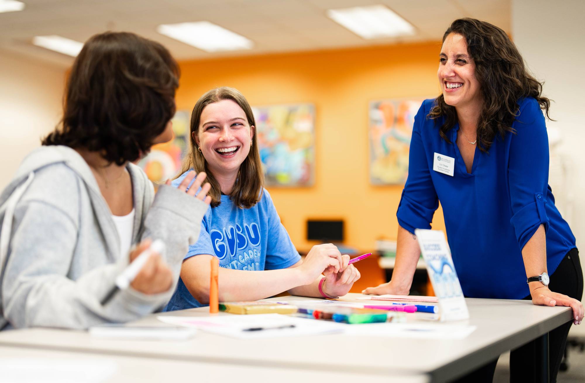 Student Success Coach chatting with students in the Student Academic Success Center